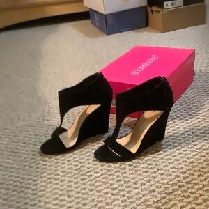 Woman’s black suede dress sandals.